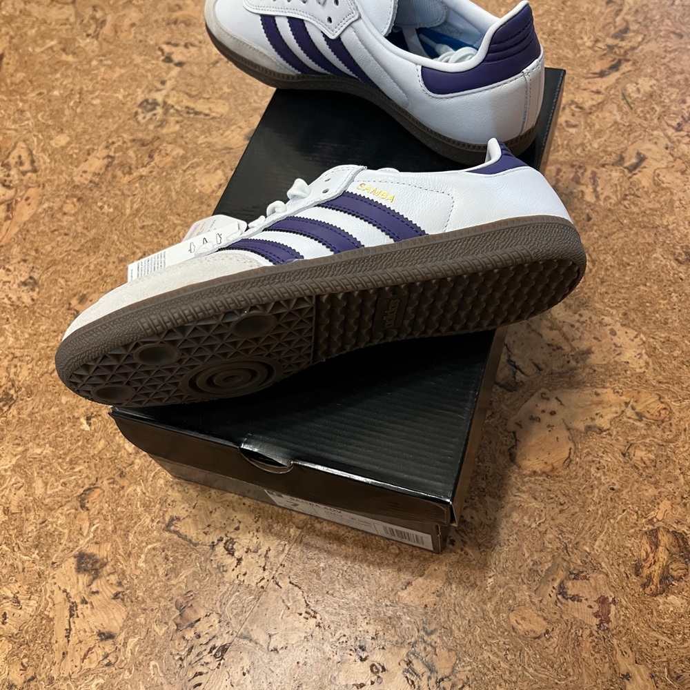 White samba with purple stripes. Fits a women’s size 7.